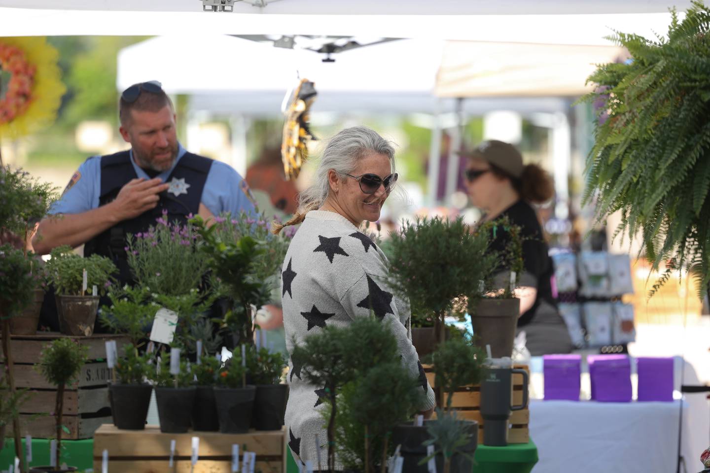 Michele Arana-Bianchi stands by her Internode Greenery and Home stand at the weekly Farmers Market in downtown Joliet on Saturday, May 11, 2024.