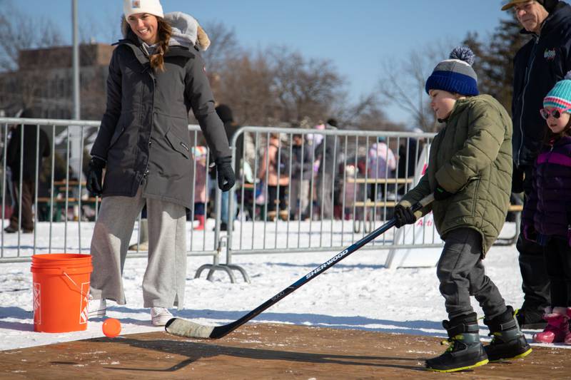 Coen, 7, of Wheaton shoots the puck at the hockey activity during Wheaton Park District's Ice-A-Palooza at the Central Athletic Complex in Wheaton on Saturday, Feb. 4, 2023.