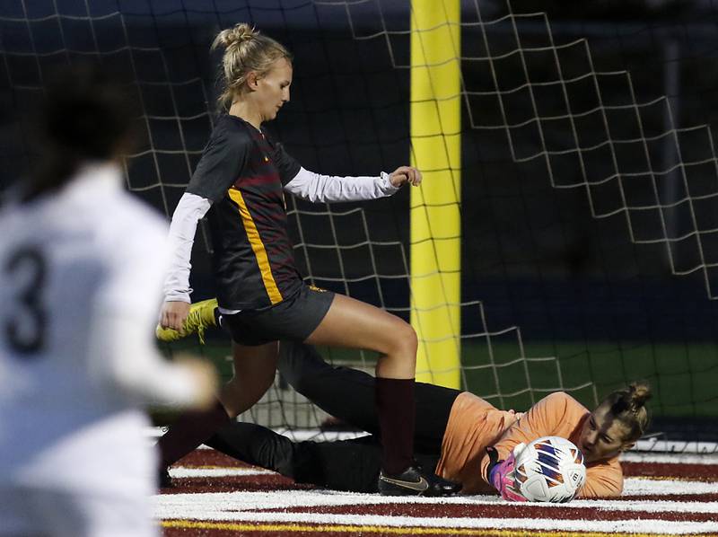 McHenry’s Makenna Harvey saves the ball as Richmond-Burton’s Margaret Slove pressures the goalkeeper during a non-conference girls soccer match Thursday, March 16, 2023, at Richmond-Burton High.