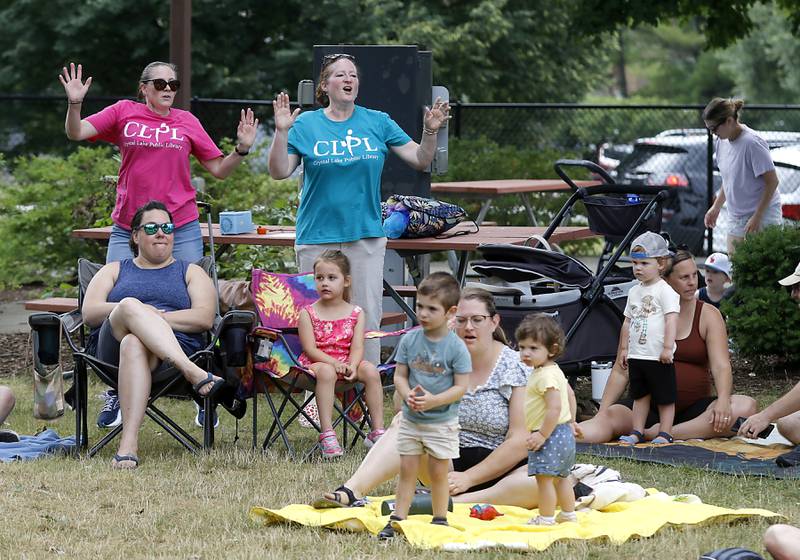 Crystal Lake Library staff members, Jamie Klinefelter and Seanie Brady dance wit the music of the Being Bilingual Rocks (BBR) Band =during the Crystal Lake Park District and Public Library's Summer Singalong for Kids on Friday, June 21, 2024, at Crystal Lake's Main Beach.