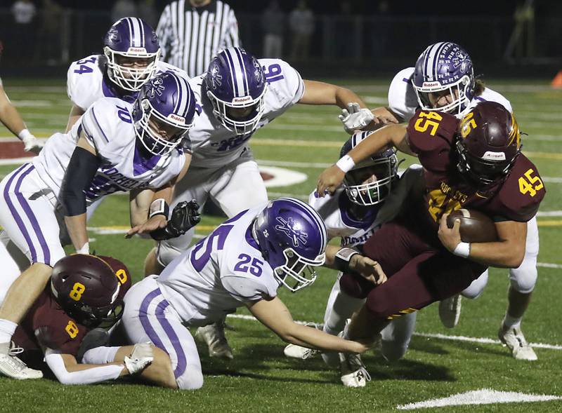 Richmond-Burton's Braxtin Nellessen tries to spin out of the defense of Rochelle during a Kishwaukee River/Interstate 8 (Blue) Conference football game on Friday, Oct.20, 2023, at Richmond-Burton High School.