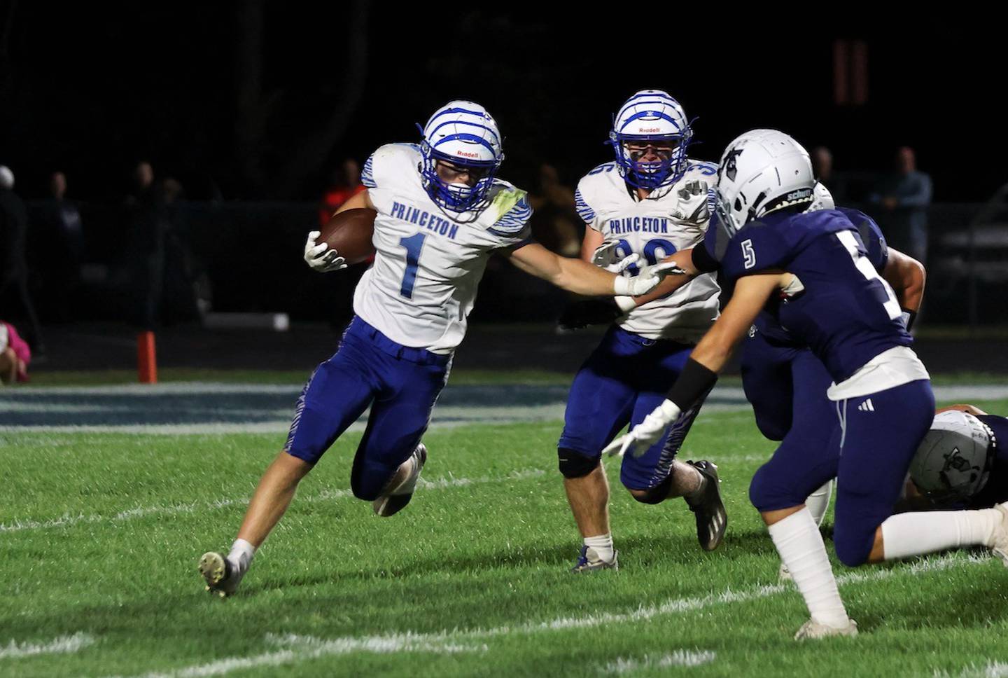 Princeton's Casey Etheridge tries to avoid Monmouth-Roseville's Clay Casteel Friday at Monmouth. The Tigers lost 31-3.