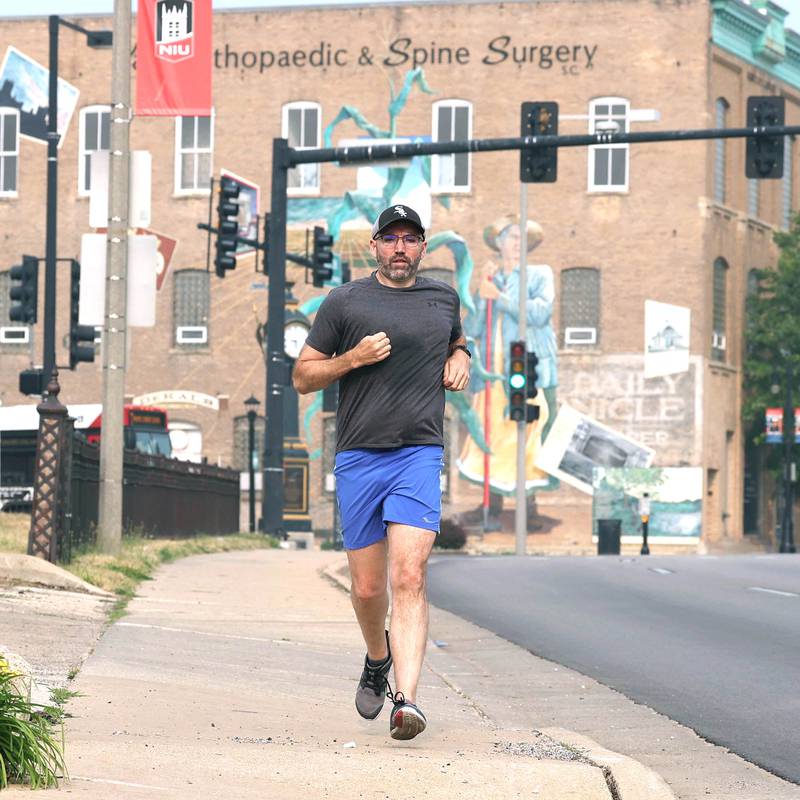 Shawn Beck, from DeKalb, runs west Wednesday, June 28, 2023, on Lincoln Highway just west of First Street in DeKalb. Beck recently completed his goal of running every street in DeKalb County.