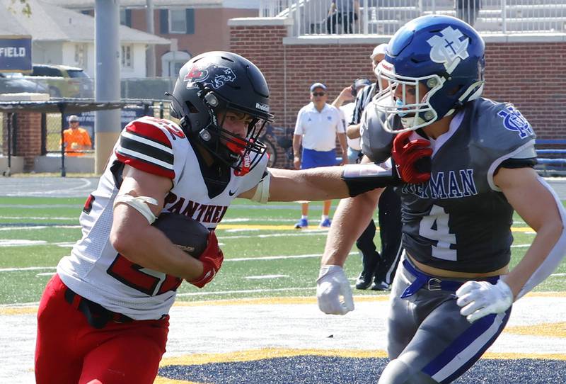 EP's Tristan Hovey stiff arms his way past competitor Newman Catholic's Matthew Blackert in Sterling on Saturday, The hosting Comets came out on top, beating the Panthers 49-14