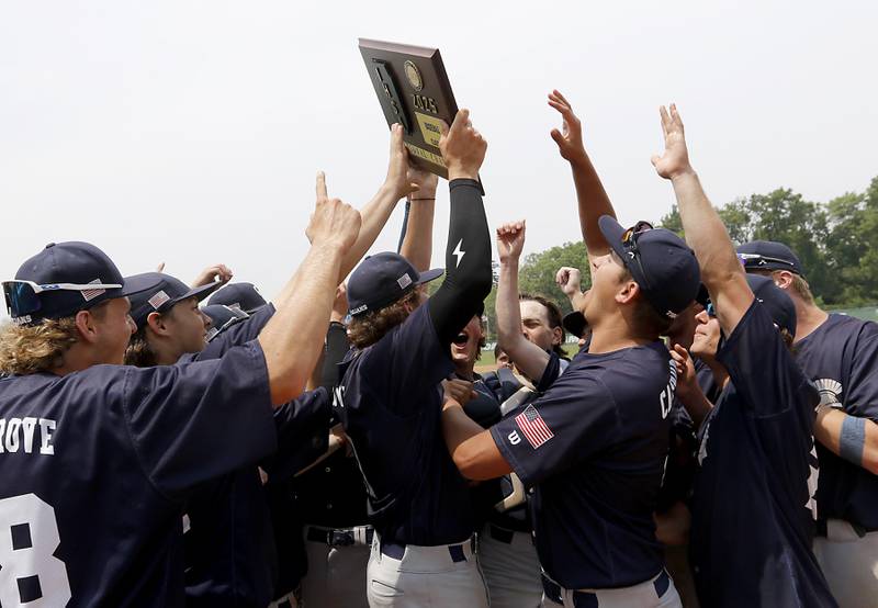 Cary-Grove's Kaden Norman raises the trophy after Cary-Grove defeated Crystal Lake South in  the IHSA Class 3A Grayslake Central Sectional Championship baseball game on Saturday, June 7, 2025, at Grayslake Central High School.