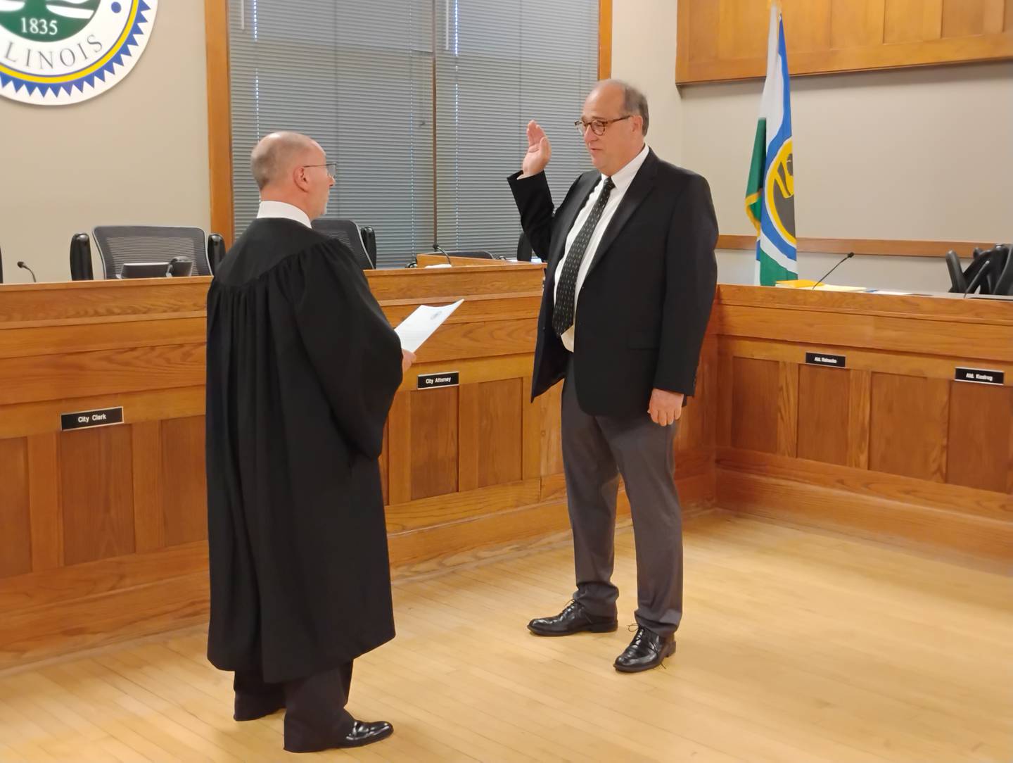 Associate Judge William Engerman swears in Larry Furnish Monday, May 5, 2025, as a new alderperson in Geneva's 3rd Ward.
