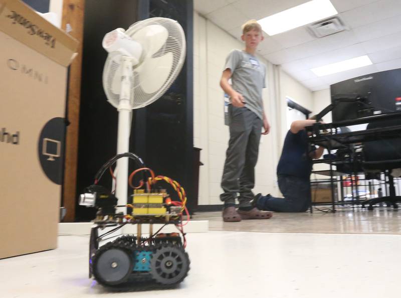 Alex Lovgren moves a robot that he built in computer programing class during the Area Career Center Hands-On Showcase on Thursday, June 8, 2023 at La Salle-Peru Township High School.