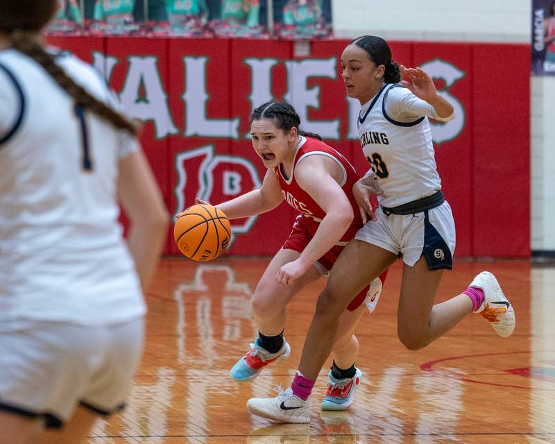 Mary Stisser (23) of Ottawa dribbles ball around Nia Harris (10) of Sterling during Regional Championship game on Thursday, Feb. 19, 2026 in Sellett Gymnasium at L-P High School.