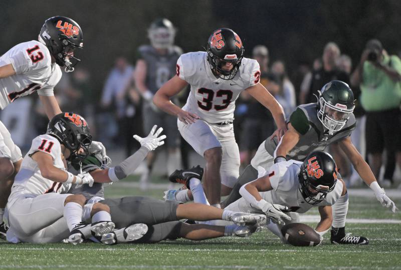 Libertyville’s Sam Sethjumps on a fumble in the first quarter against Stevenson in a football game in Lincolnshire on Friday, Sept. 13, 2024.