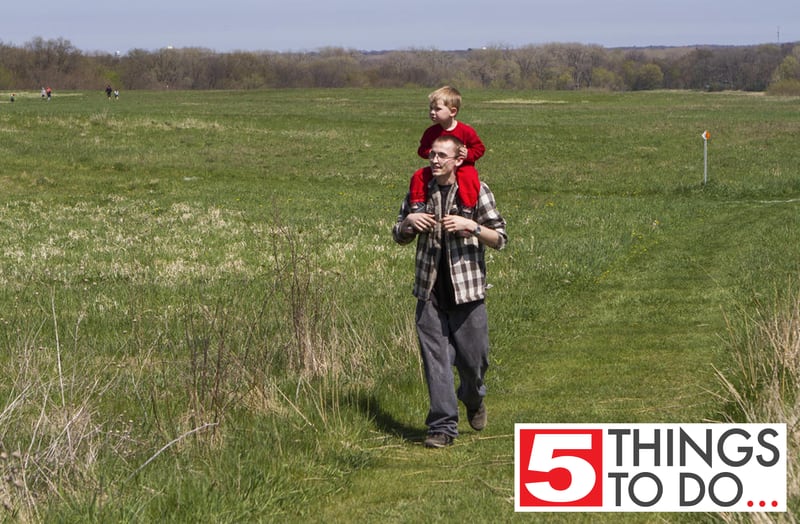 Cory Moore, of Crystal Lake, walks through the prairie with son Jackson, then 3, during the Earth Day Celebration on Saturday, April 23, 2016, at Prairieview Education Center in Crystal Lake. The event included guided nature hikes, games and crafts, puppet Shows, over 20 environmental exhibitors, as well as food & beverage vendors.