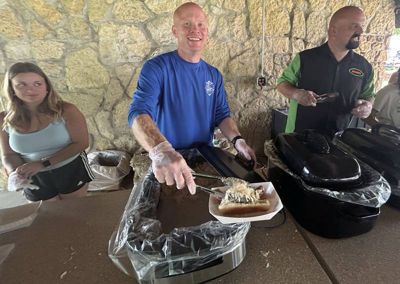 Addison Schleich, Ryan Howell, and Jeremy Whitehead were busy serving up sauerkraut with brats and hot dogs at the luncheon at Sauerkraut Days in Forreston on Saturday, Aug. 2, 2025.