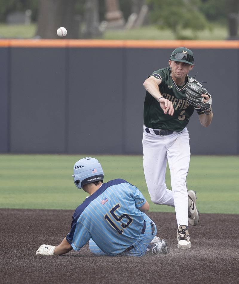Father McGivney’s Ty Etcheson fires to first to complete the double play as Ottawa Marquette’s Alec Novotney slides in at second Saturday, June 7, 2025, during the Class 1A state baseball final at Illinois Field in Champaign.