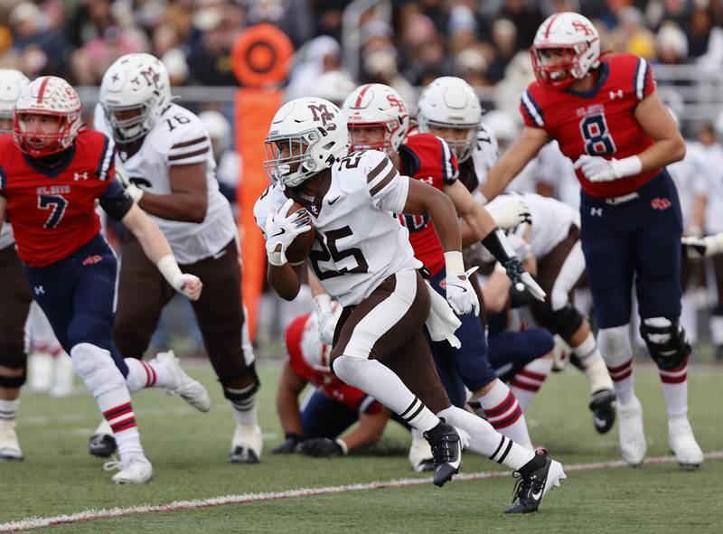 Mt. Carmel's Madden Wilson (25) runs the ball during the class 7A semi-final playoff game between Mt. Carmel and St. Rita high schools on Saturday, Nov. 23, 2024 in Chicago.
