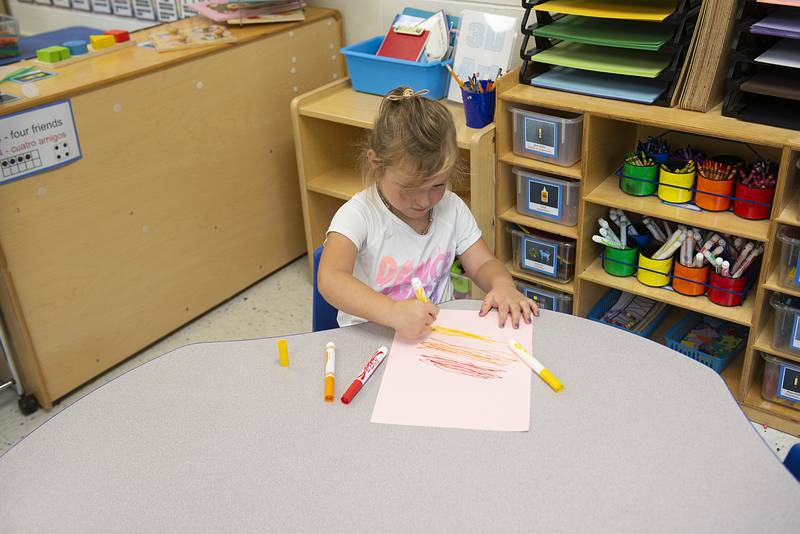 Students at Riverview Preschool Center can choose, at one point of the school day, between a snack or play time. Burkley headed straight for the art rack to begin her next masterpiece.