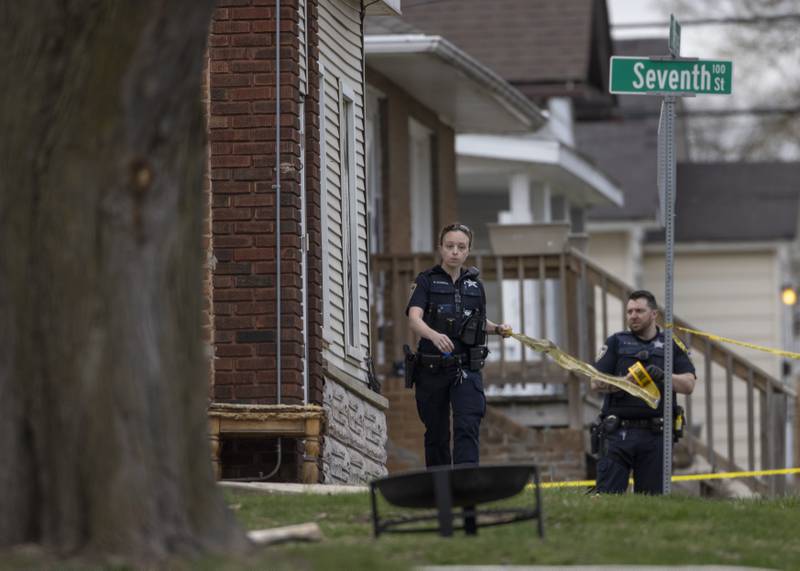 Police officers tape off the yard of of a two-story apartment building on the corner of Seventh and Charters on Sunday, March 30, 2025 in La Salle. A barricaded armed subject fired shots at officers. Police from across the Illinois Valley assisted in the incident.