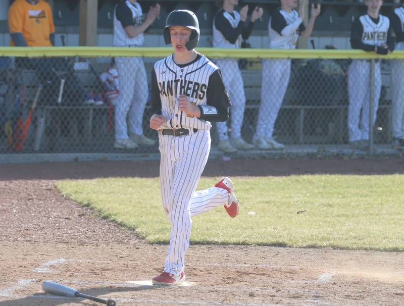 Putnam County's Drew Carlson crosses home plate to score first against Hall on Monday, March 17, 2025 at Putnam County High School.