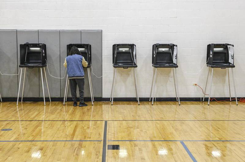 A voters casts their ballot Tuesday, March 17, 2020, at Judson Church during Illinois' Primary Election in Joliet, Ill.