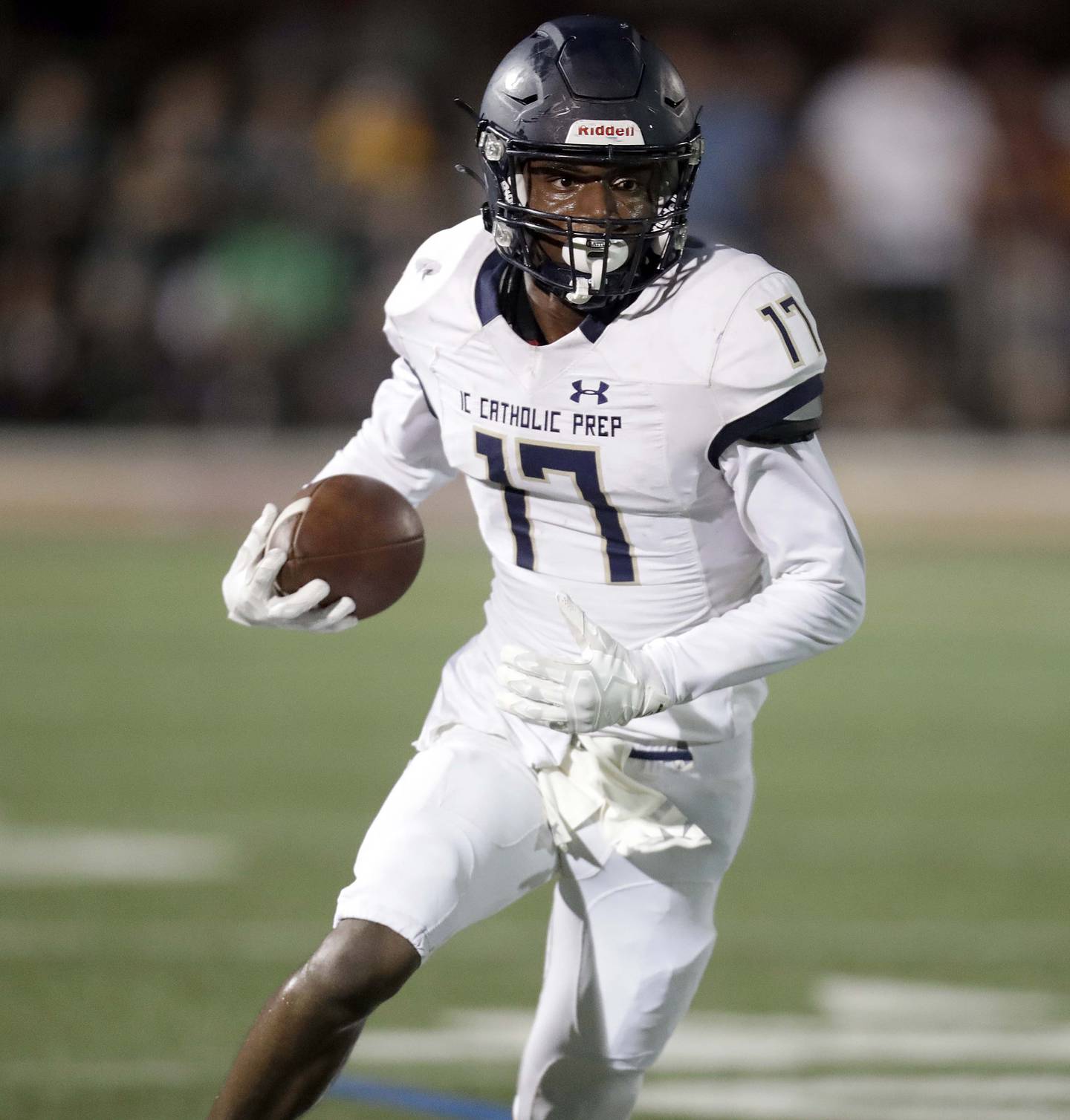 IC Catholic Prep's Antonio Richardson (17) looks for running room against Montini during football Friday August 27, 2021 in Lombard.