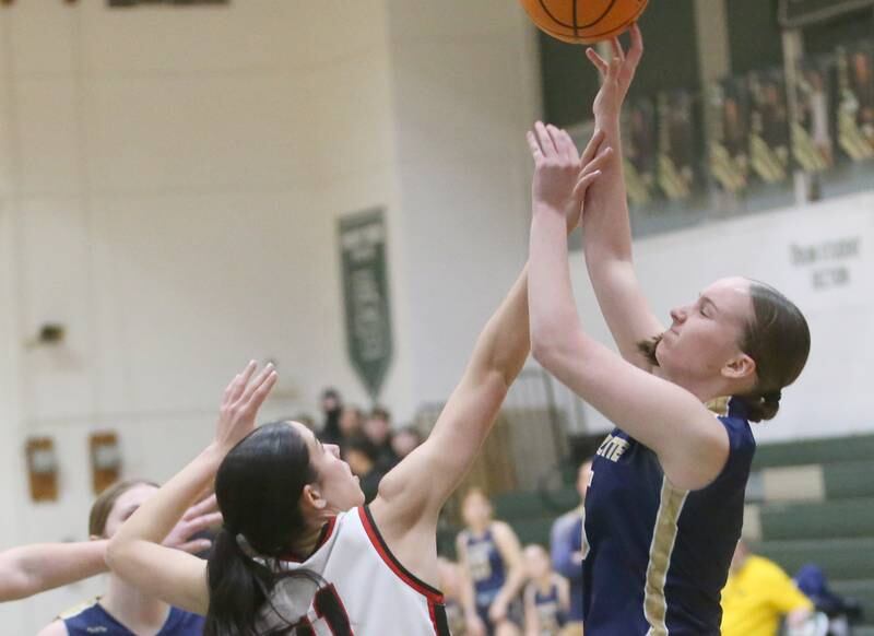 Marquette's Chloe Larson eyes the hoop as Amboy/Ohio's Tyrah Vaessen defends during the Class 1A Regional championship on Thursday, Feb. 20, 2025 at St. Bede Academy.