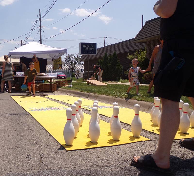 Children took their turn street bowling Saturday, June 3, 2023, during the Summer Reading Kick-Off Party at Reddick Library in Ottawa.