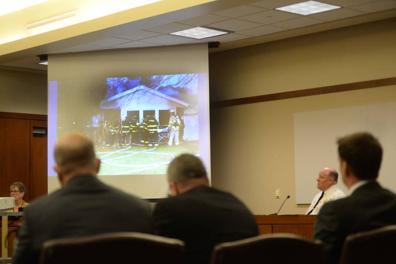 Mount Morris Fire Chief Rob Hough testifies at the Ogle County Judicial Center in Oregon on Tuesday, March 19, 2024 as defendant Matthew Plote and his attorneys Liam Dixon and John Kopp listen.