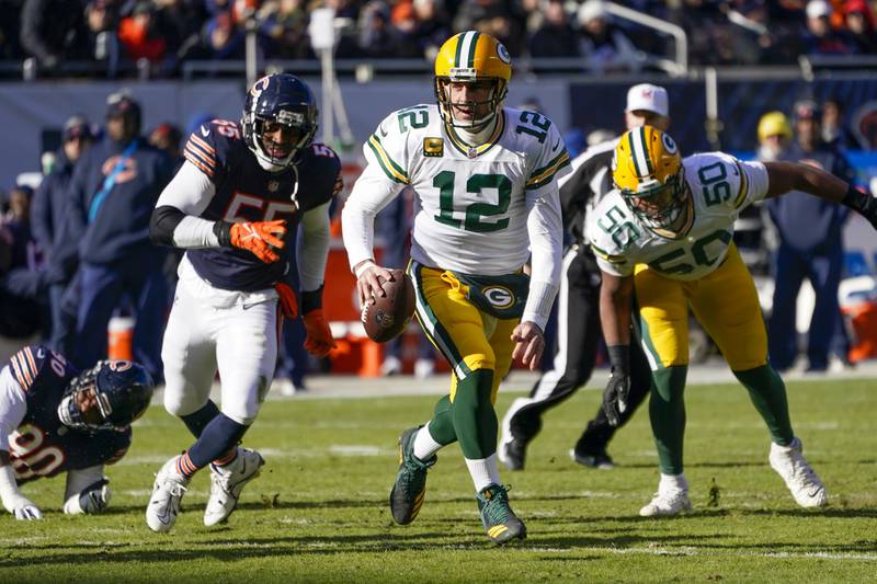 Green Bay Packers quarterback Aaron Rodgers scrambles during the first half against the Chicago Bears, Sunday, Dec. 4, 2022, in Chicago.