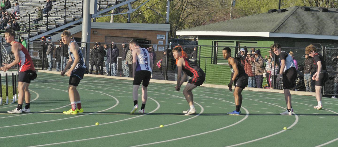 Runners await the baton handoff ahead of the last leg of the boys 4x100 relay at the Rock Falls Rocket Invite at Hinders Field on Friday, April 19, 2024.