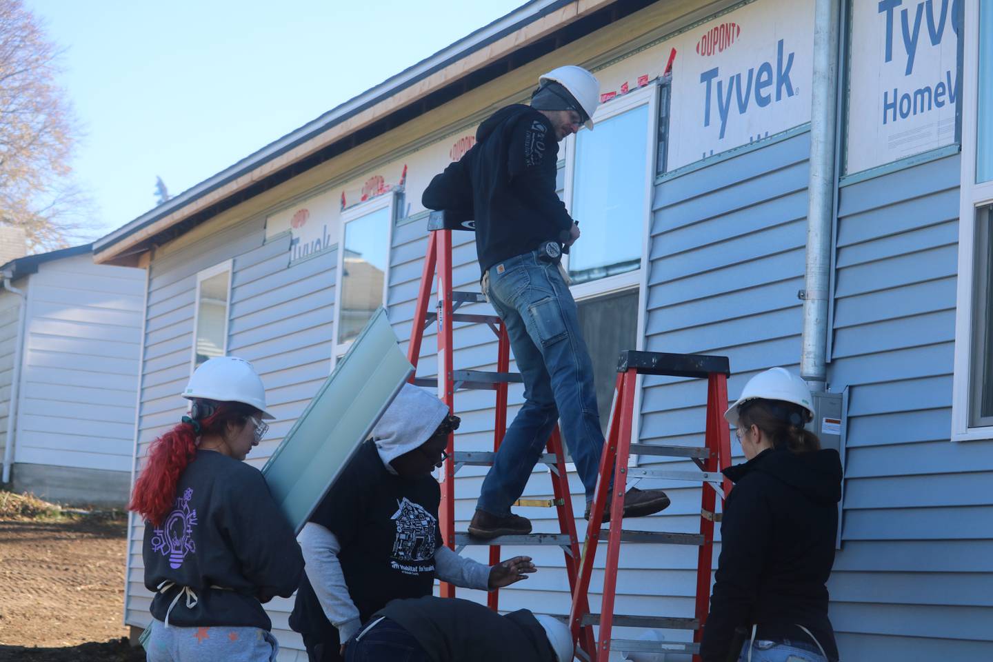 Volunteers for Habitat for Humanity of DeKalb County install siding on the Gonzalez's home Nov. 11, 2023 during the organization's third of three Women Build events in Kingston.