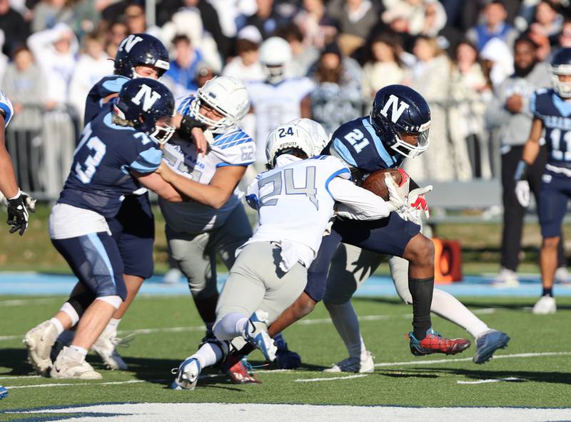 Nazareth's Lesroy Tittle (21) breaks free for a touchdown run against St. Francis during the boys varsity IHSA 5A semifinal between Nazareth Academy and St. Francis high school in La Grange Park, IL on Saturday, Nov. 18, 2023.