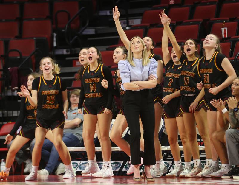 Members of the Montini girls basketball team react with head coach Shannon Spanos while playing Quincy Notre Dame during the Class 3A State semifinal game on Thursday, March 6, 2025 at CEFCU Arena in Normal.
