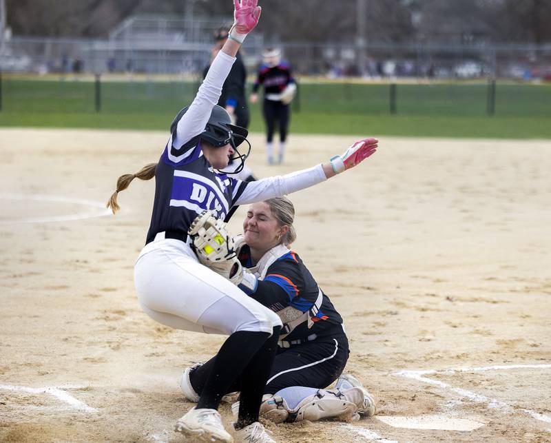 Dixon’s Bailey Tegeler is tagged out at home by against Genoa-Kingston’s Ari Rich Monday, April 7, 2025.