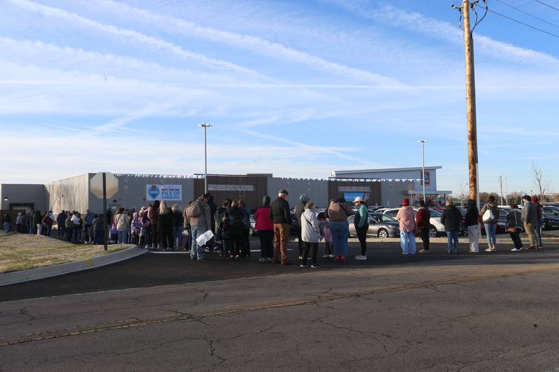 Hundreds of people wait in line to enter the new Aldi grocery store on Thursday, Nov. 13, 2025 at the corner of Backbone Road and North Main Street  in Princeton. The 12,000 square feet store began construction in May of this year. The first 100 people in line were given a chance to win a golden ticket to win a $100 gift card. Hundreds of people waited in line for free gift bags. The store hours are 9a.m.-8p.m. daily.