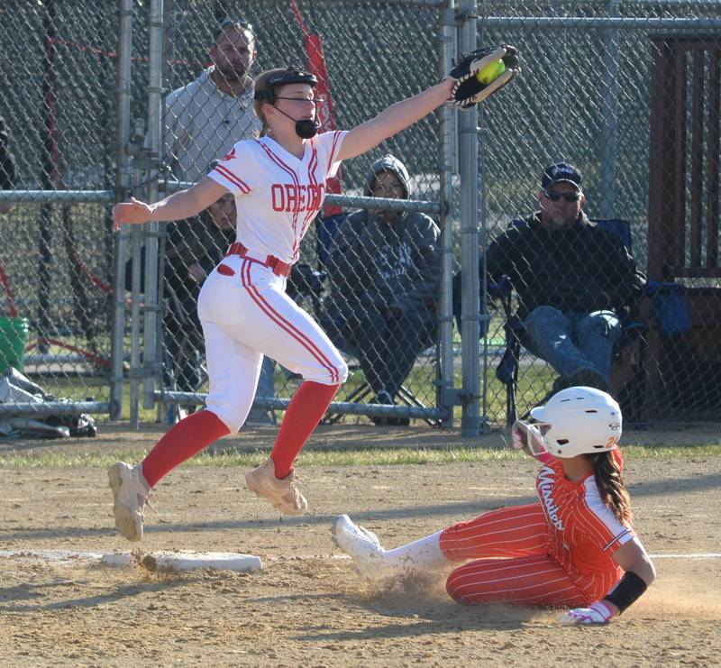 Oregon third baseman Kylie Morrow reaches for a throw as Milledgeville's Lexis Grenoble slides safely to the base on Monday, March 23, 2026 at Oregon Park West.