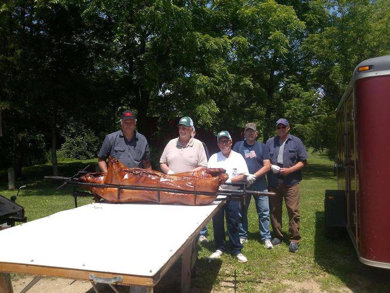 Steve Henke (left) used to cook hogs with the help of other church members, including with his longtime friend Robert Wilson (middle, white shirt.) Henke said it was good news that an arrest was made in the 2016 killing of Wilson and his mother, Patricia.