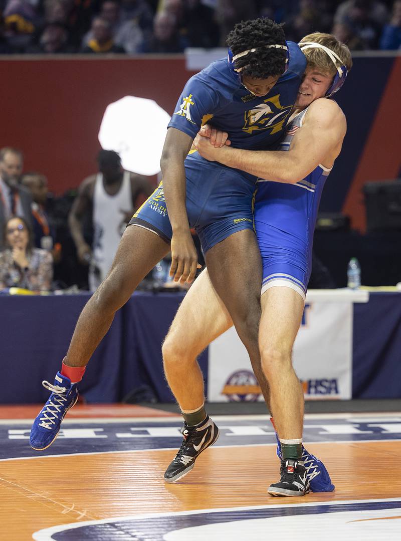 Princeton’s Casey Etheridge lifts Althoff’s Pierre Walton in the 1A 165 pound class Saturday, Feb. 21, 2026, at the IHSA wrestling finals in Champaign.