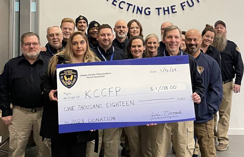 The Oswego Police Citizen’s Police Academy Alumni Association presented a check to Kendall County Food Pantry assistant director Dulce Vargas.