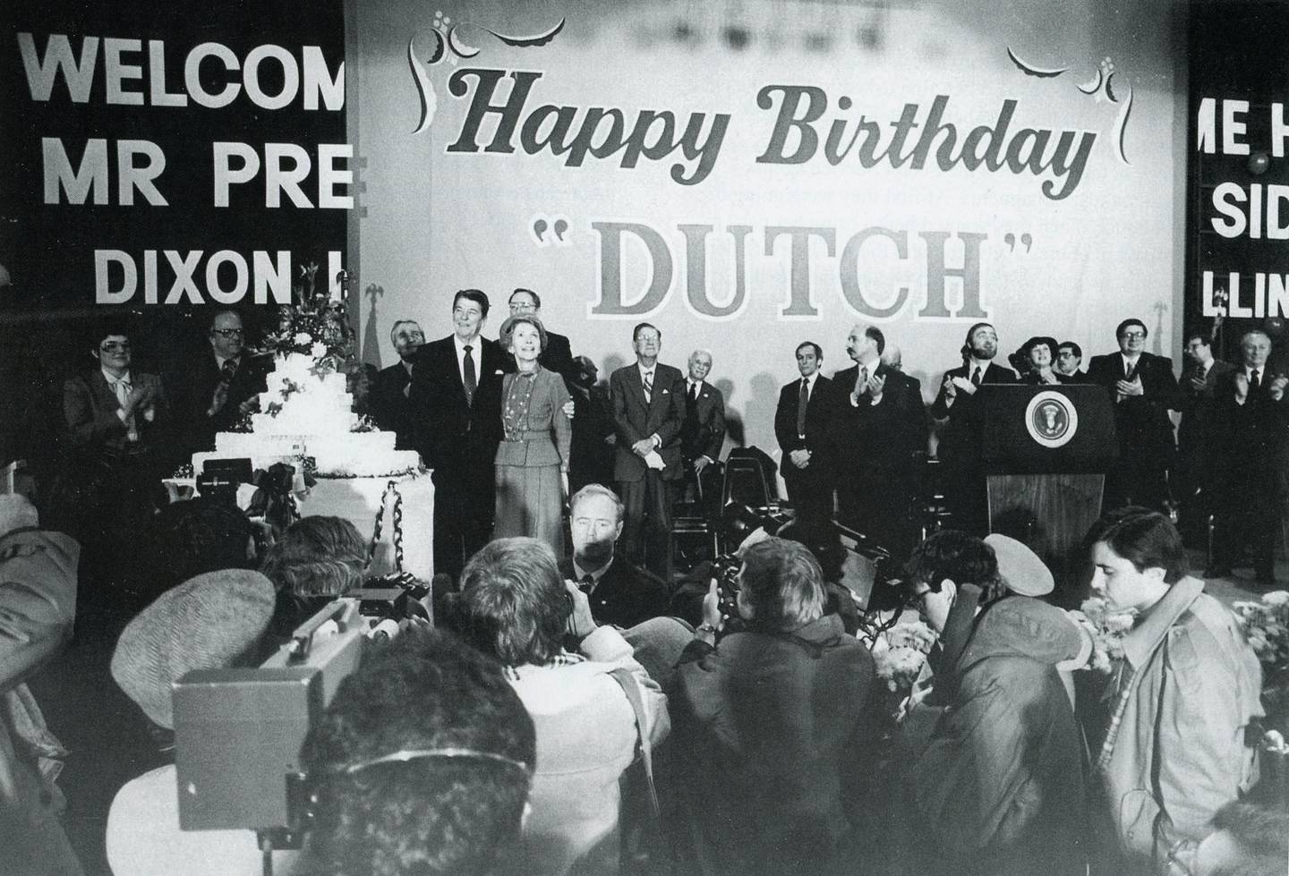 The president reviews his birthday cake at Lancaster Gym.