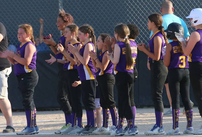 Members of the Warriors softball team applaud during the Ottawa Girls Fastpitch Association 11U City Championship on Wednesday July 2, 2025 at Peck Park in Ottawa.
