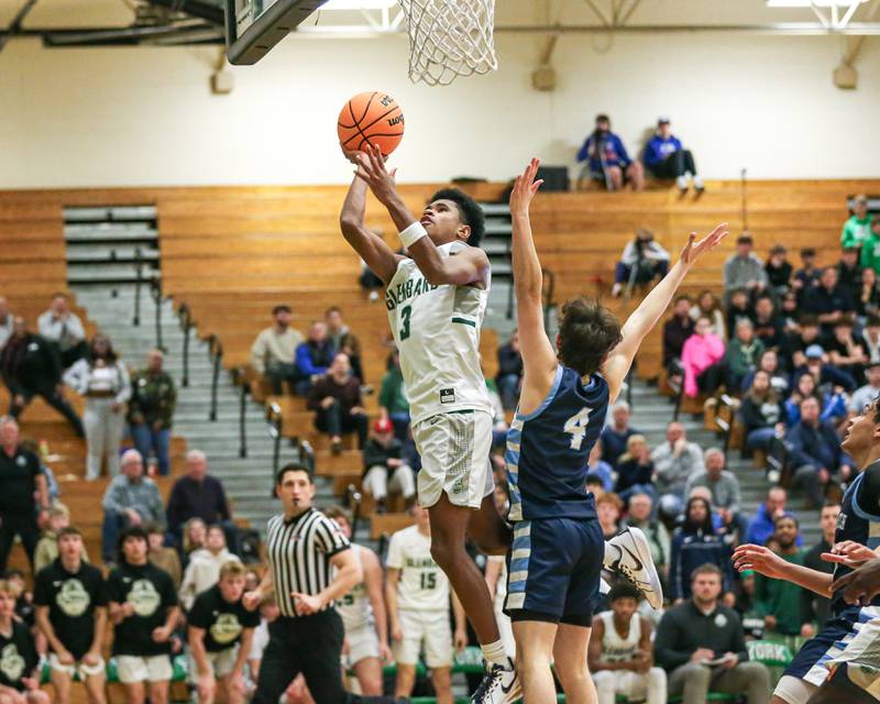 Glenbard West's TJ Williams (3) puts up a layup attempt during their Jack Tosh Holiday Classic basketball tournament game between Nazareth vs Glenbard West. Thursday Dec 26, 2024 in Elmhurst.