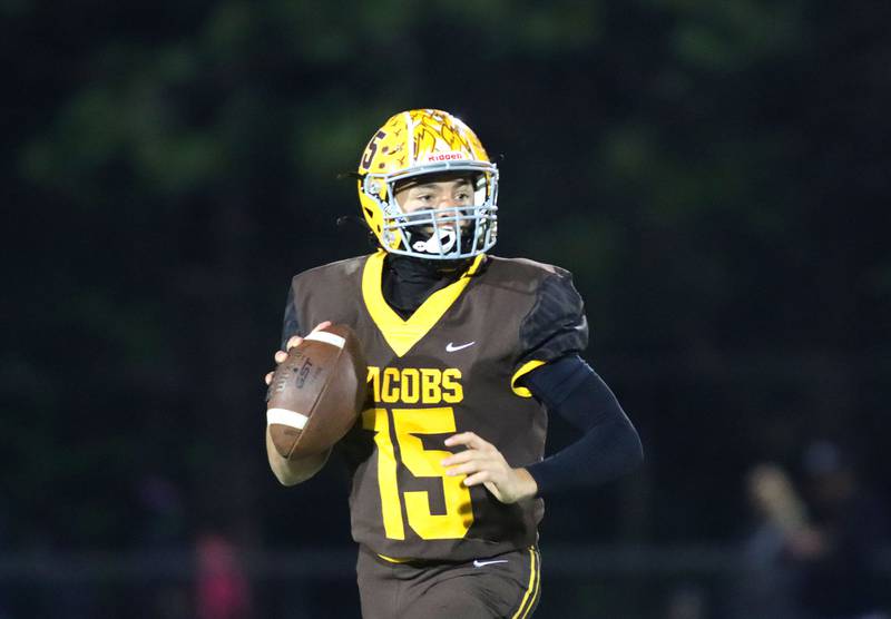 Jacobs’ Austin Stennett looks for an option against Dundee-Crown in varsity football  at Jacobs High School in Algonquin on Friday, Oct. 10, 2025.
