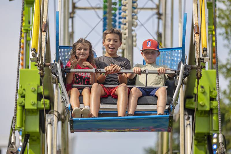 Eli Hatheway (left), 6, Huck Hatheway, 10, and Charlie Neisemier, 10, all of Oregon, ride the Ferris Wheel Wednesday, August 6, 2025, at the Carroll County Fair.