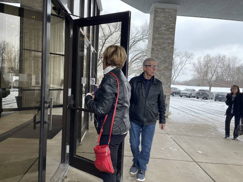 Sam Smith (right) holds the door open for Toots Kelley as both get set to attend a speaking event featuring conservative activist Charlie Kirk on Saturday, Feb. 25, 2023, at the Holiday Inn in Crystal Lake.