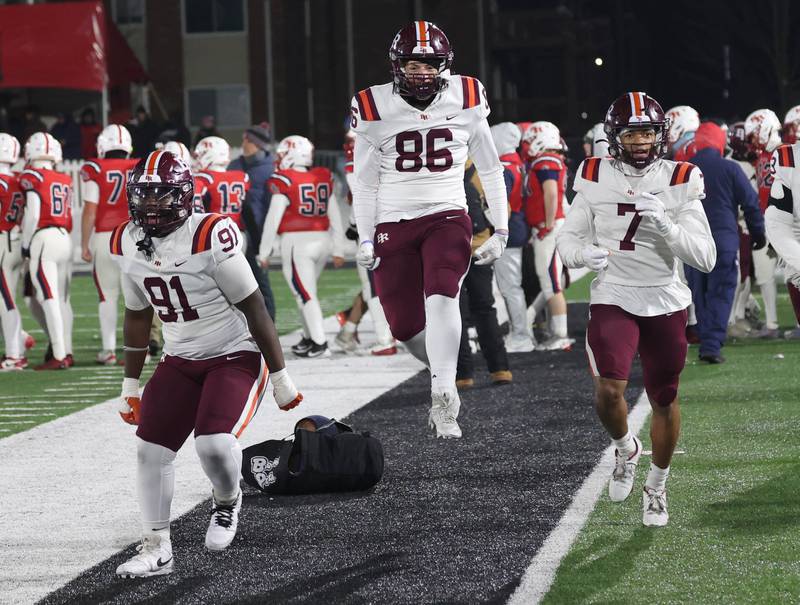 Brother Rice players celebrate Wednesday, Dec. 3, 2025, after their IHSA Class 7A state chamionship win over St. Rita in Huskie Stadium at Northern Illinois University in DeKalb.