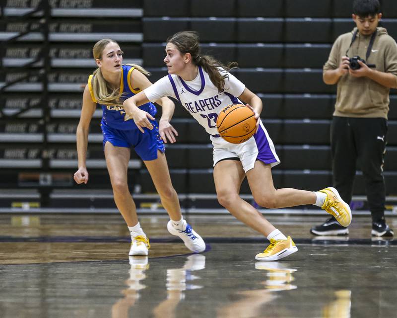 Plano's Josie Larson (23) makes a move on the defense during their basketball game between Johnsburg at Plano, Monday Dec 16, 2024 in Plano.