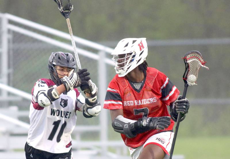 Huntley’s SJ Engmann, right, moves the ball as Prairie Ridge’s Trenton Horton defends  in varsity boys lacrosse at Prairie Ridge  High School in Crystal Lake on Thursday, May 1, 2025.