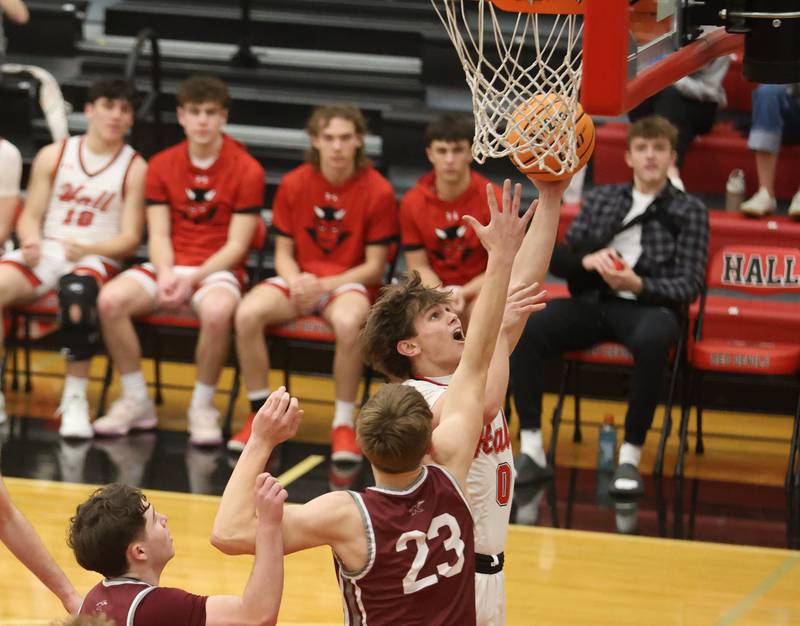 Hall's Noah Plym lets go of a three point basket over Rockridge's Kameron Wilkerson during the Class 2A Regional quarterfinal game on Monday, Feb. 23, 2026 at Hall High School.