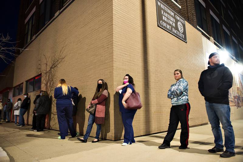 Voters line up outside of the Whiteside County Courthouse in Sterling Tuesday evening, waiting to vote in the general election.