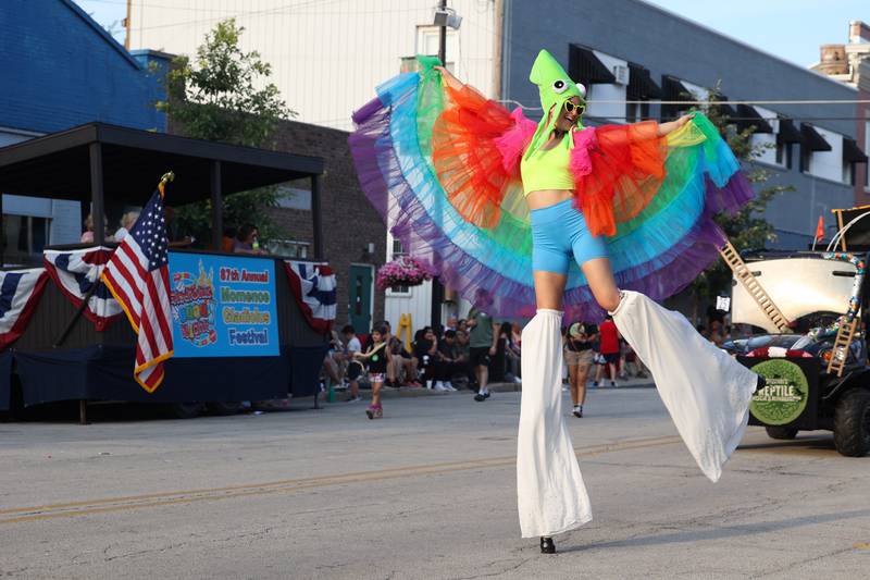 A parade participant strikes a pose on stilts during the 87th Momence Gladiolus Festival Main Street Parade on Friday, Aug. 8, 2025.