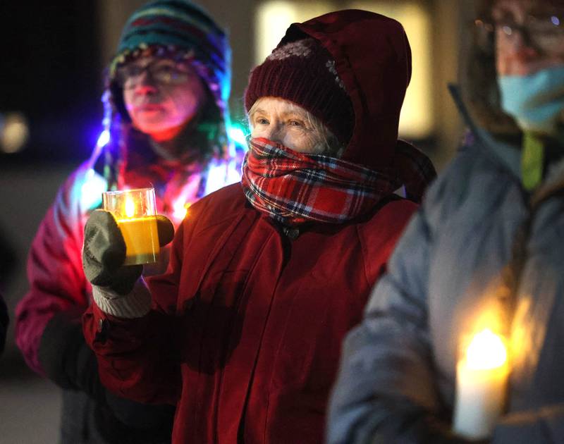 Attendees hold candles Monday, Jan. 26, 2026, during a vigil outside the DeKalb County Legislative Center in Sycamore after second shooting death in Minnesota involving ICE officers.