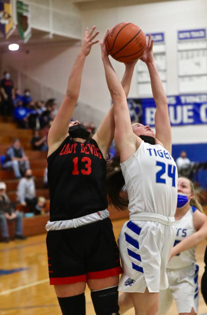 Hall's McKenna Christiansen (13) and Princeton's McKenzie Hecht battle for a rebound Monday night at Prouty Gym. The Tigresses rallied for a 40-32 victory.